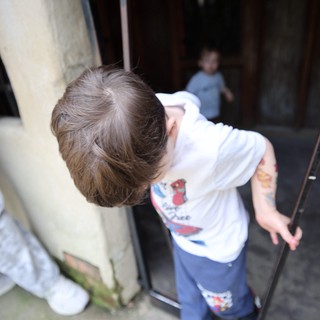 Young Boy Peering Through Mysterious Doorway at Fantasyland