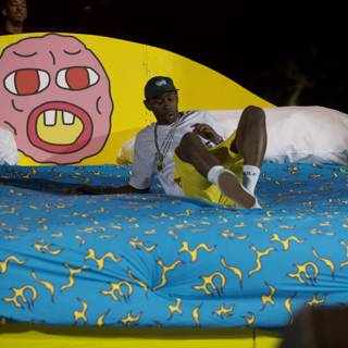 Tyler, The Creator lounging with his cartoon friend