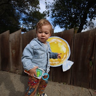 Toddler Playing with Toy Fishing Set in Backyard