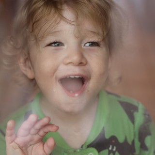 Joyful Toddler with Bright Smile and Wavy Hair