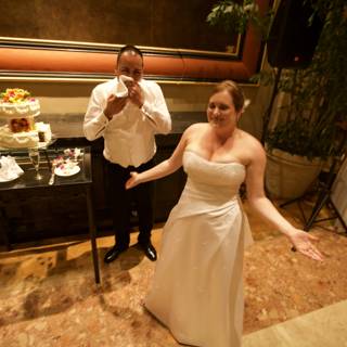 Wedding Couple Poses in Front of Luxurious Wedding Cake