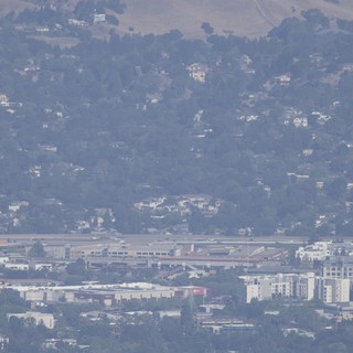 mountain-viewpoint-overlooking-urban-area-and-airport