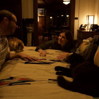 Couple Relaxing on Bed with Cats at Night