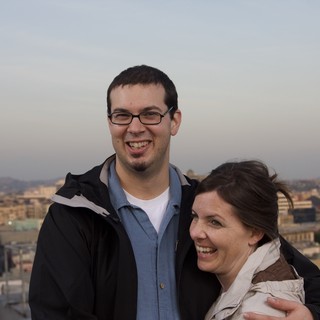 Couple Smiling Together Against City Skyline