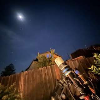 Backyard Telescope Under Moonlit Night Sky