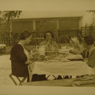 Three women enjoying a meal at a dining table