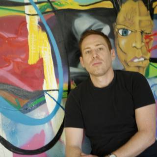 Portrait of a Man in Front of a Colorful Wall