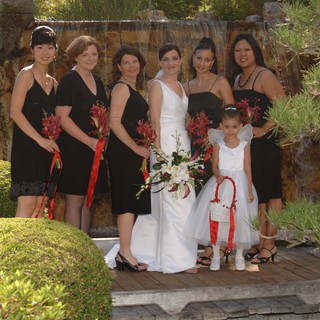 Bride and Bridesmaids Pose Before Garden Waterfall