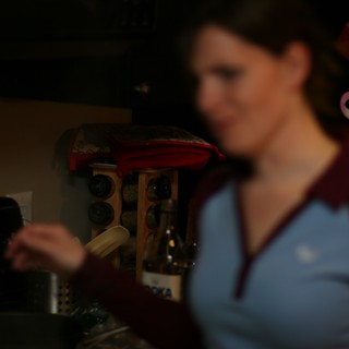 Woman Smiling in Dimly Lit Home Kitchen