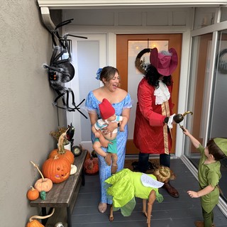 Family Halloween Trick-or-Treating at Front Door