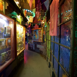 Colorful Narrow Alleyway with Festive Decorations and Art