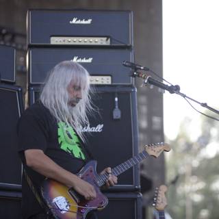 The White-Haired Guitarist: A Musical Performance on Stage