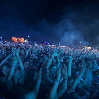 Festivalgoers Raise Hands in the Night Sky