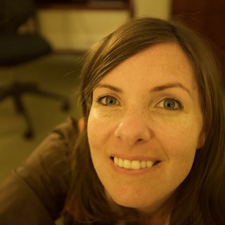 Smiling Woman with Blue Eyes in Office Setting