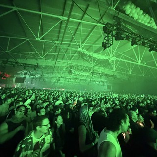 Massive Crowd at Electronic Music Concert Under Green Lights