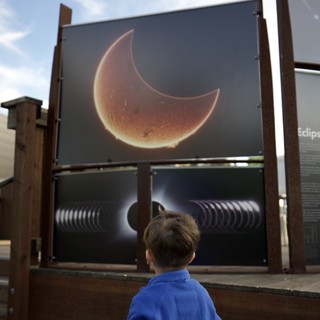 Child Observing Solar Eclipse Educational Display