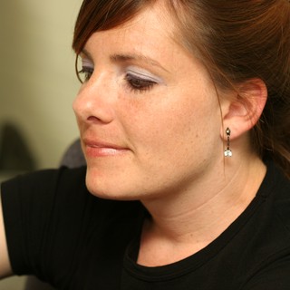 Thoughtful Woman in Profile with Statement Eye Makeup