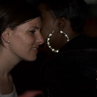Two Women in Conversation at Dimly Lit Venue