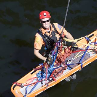 Orange Shirted Man Holds Safety Raft