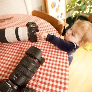 Young Child Napping with Photography Equipment at Christmas