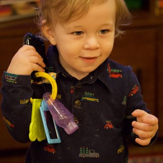 Toddler Playing with Toy Keys and Phone