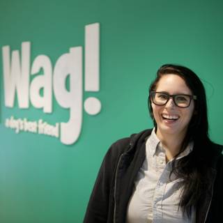 Happy Woman in Glasses with Wag Logo