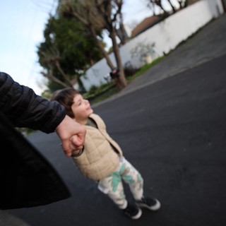 Parent and Child Walking Hand in Hand at Dusk
