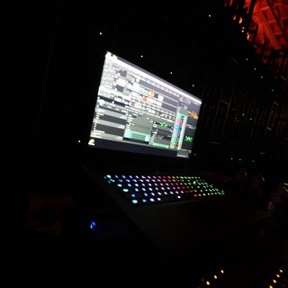 DJ Laptop Setup Glowing at Dark Festival Stage
