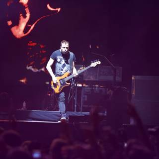 Christopher Wolstenholme Rocking the Stage with his Guitar