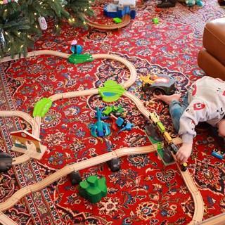 Child Playing with Wooden Train Set on Christmas Day
