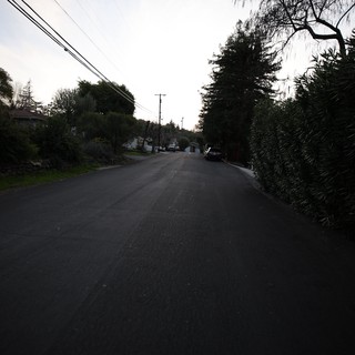 Quiet Residential Street at Dusk with Overhead Power Lines