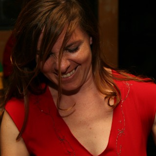 Joyful Woman in Red Laughing at Party
