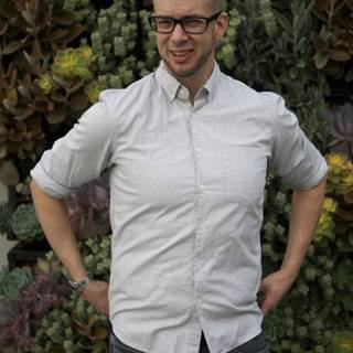 The Happy Man with a Wall of Succulents