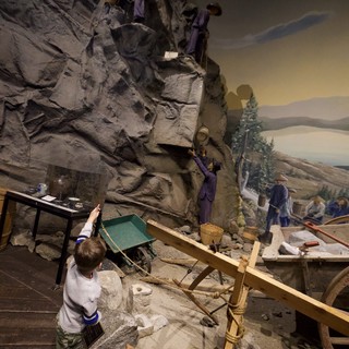 Child Exploring Interactive Museum Mining Exhibit Display