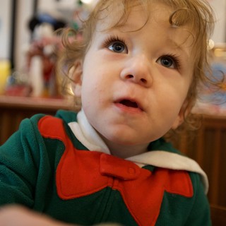 Curious Toddler in Festive Elf Costume
