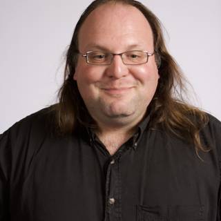 Portrait of Ethan Zuckerman holding a coffee cup