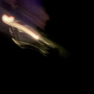 Light Trails Through Purple Night Sky