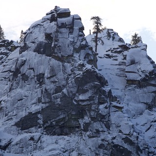 Snow-Covered Rocky Peak in Winter Mountain Landscape