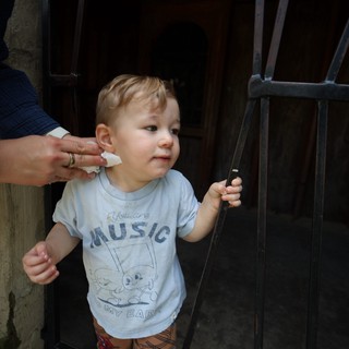 Young Child Getting Ear Cleaned by Parent