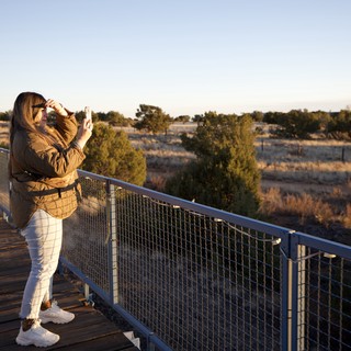 Woman Photographing Sunset at Desert Overlook