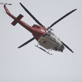 Red and White Helicopter Taking Flight