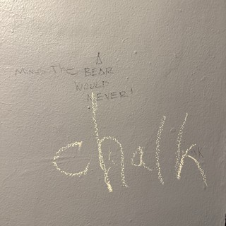 Hand-Drawn Graffiti Message on Textured Wall