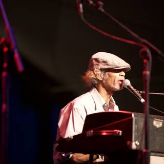 Man in Hat Shines on Keyboard at Coachella Music Festival