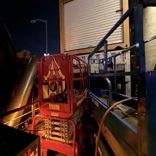 Red Scissor Lift at Night Industrial Loading Dock