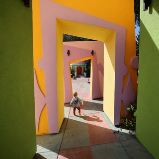 Child Walking Through Colorful Architectural Tunnels at Fantasyland