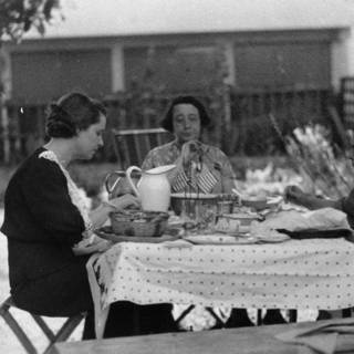 Three Women Enjoying a Meal Outside