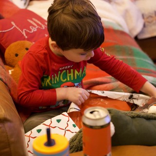 Child Opening Christmas Presents on Christmas Morning