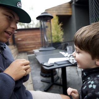 Brothers Sharing a Moment on an Outdoor Patio