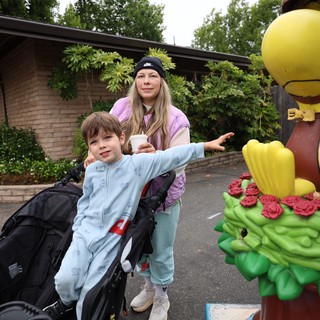 Mother and Child Pose with Woodstock Cartoon Statue