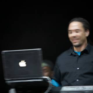 Roni Size Smiling with Laptop